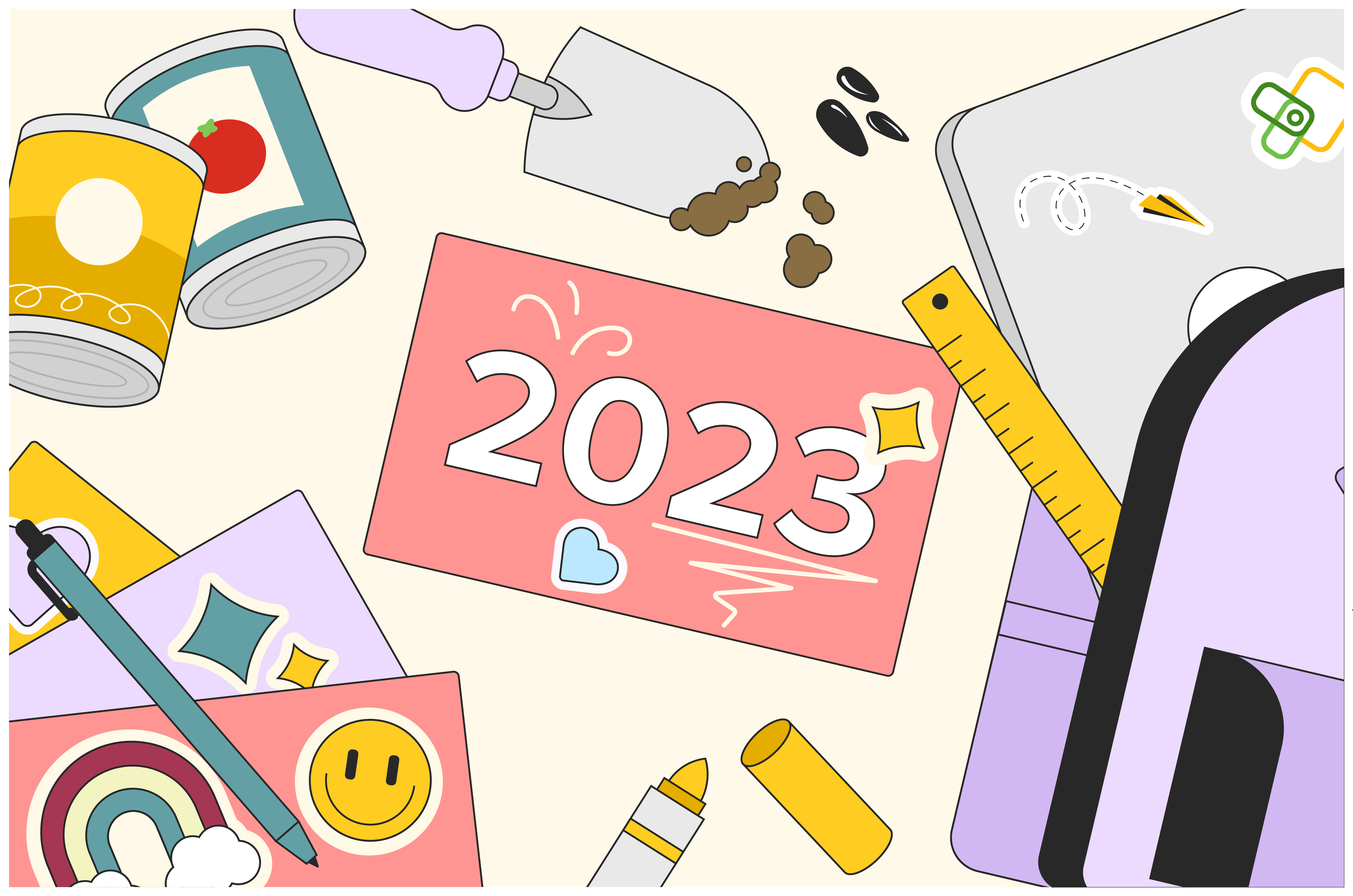 A card thats written 2023, surrounded by various stationery items such as pens, paper, a ruler, markers, and cans.