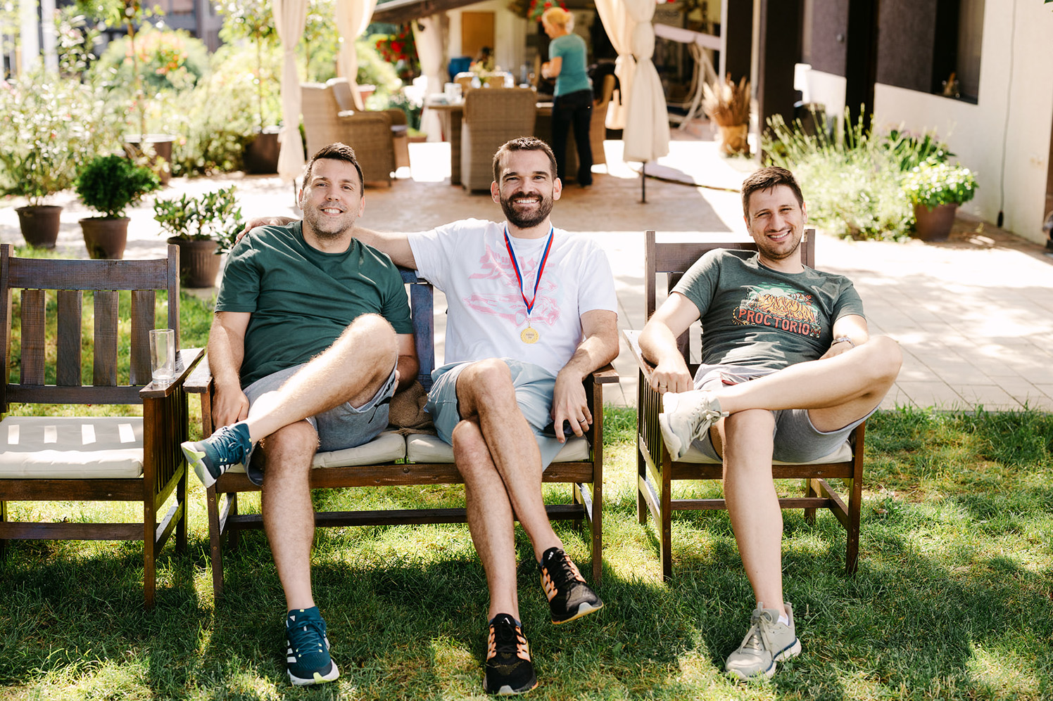 Three Proctorio employees relaxing outside the office